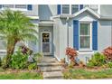 Inviting front entrance with a well-manicured garden and charming accents at 10429 Heron Lake Dr, Riverview, FL 33578
