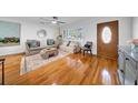 Bright living room with hardwood floors, large windows, and stylish neutral furniture at 307 N Glen Ave, Tampa, FL 33609
