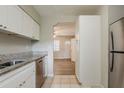 Functional kitchen features modern appliances, granite countertops, and ample white cabinet space at 4226 E Emma St, Tampa, FL 33610