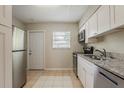 Functional kitchen featuring stainless steel appliances, granite countertops, and ample cabinet space with a backyard access at 4226 E Emma St, Tampa, FL 33610