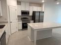 Modern kitchen with white cabinets, stainless steel appliances, and granite countertops at 32122 Eastern Redbud Br, San Antonio, FL 33576