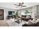 Inviting living room with a large window providing natural light, comfortable seating, and a ceiling fan at 5511 1St Avenue Nw Dr, Bradenton, FL 34209