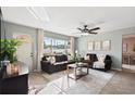 Bright living room featuring neutral paint, tile floors, large window and comfortable seating at 5511 1St Avenue Nw Dr, Bradenton, FL 34209