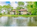 Picturesque two-story condo overlooking a tranquil pond with a fountain and mature trees at 870 Village Lake N Ter # 204, St Petersburg, FL 33716