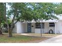 Charming single-story home with a blue front door and mature landscaping at 2580 68Th S Ave, St Petersburg, FL 33712