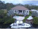 Beautiful home with a private boat dock, lush landscaping, and outdoor seating area perfect for entertaining at 608 Bittner Blvd, Nokomis, FL 34275