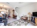 Bright living room with tile flooring, white staircase, and comfortable seating area with a floral rug at 232 Countryside Key Blvd, Oldsmar, FL 34677