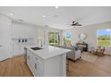 Modern kitchen with sleek countertops, stainless steel appliances, and views into the living room at 2919 Cascabel Ter, North Port, FL 34286