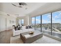 Bright living room featuring a comfortable couch, coffee table, and expansive windows with water views at 1209 E Cumberland Ave # 2101, Tampa, FL 33602