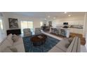 Open-concept living room featuring neutral walls, hardwood floors and abundant natural light from sliding doors at 14684 Italy Ave, Dade City, FL 33523