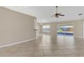 Spacious living room boasts neutral walls, tile flooring, and sliding doors to the outdoor patio at 205 Island Water Way, Apollo Beach, FL 33572