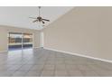 Open living space showcases tile flooring, neutral walls, and glass sliding door accessing the patio at 205 Island Water Way, Apollo Beach, FL 33572