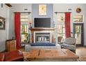 Cozy fireplace with wood mantel, tile surround, and modern TV at 36846 Perry Ct, Dade City, FL 33525