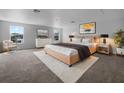 This main bedroom features large windows for natural light, modern furnishings, and neutral tones at 10768 Carloway Hills Dr, Wimauma, FL 33598