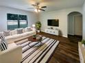 Bright living room with a plush rug, ceiling fan, and contemporary decor at 5383 Magdalene Way, Zephyrhills, FL 33541