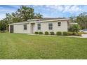 Exterior view of house with well-maintained lawn and foundation planting at 146 51St Street E Cir, Palmetto, FL 34221