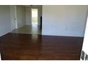 Open-concept living room featuring hardwood floors and a view into other rooms at 3347 Roxbury Dr, Holiday, FL 34691
