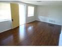 Bright living room featuring hardwood floors, natural light, and a welcoming entrance at 3347 Roxbury Dr, Holiday, FL 34691