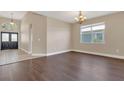 Dining room featuring dark wood-look floors and neutral paint, situated near the front entrance at 530 Bimini Bay Blvd, Apollo Beach, FL 33572