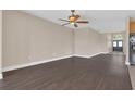 Spacious living room featuring wood-look flooring and neutral paint, leading to the front entryway at 530 Bimini Bay Blvd, Apollo Beach, FL 33572