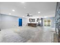 Bright and airy living room showing the open layout, kitchen, fireplace and sliding glass doors to the outside at 2302 16 W St, Palmetto, FL 34221