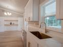 Bright kitchen with marble countertops, white cabinets, stainless steel appliances, and a view of the pool at 2435 Hawk Griffin Rd, Plant City, FL 33565