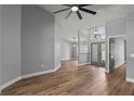 Bright living room featuring hardwood floors, gray walls, and modern ceiling fan at 1438 Mclin Dr, Plant City, FL 33565