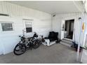 A covered outdoor patio area, with access to the home's entrance, for relaxed outdoor living at 10315 Cortez W Rd # 18D, Bradenton, FL 34210