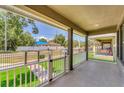 Covered front porch with white railings overlooking the fenced front yard at 3027 W Spruce St, Tampa, FL 33607