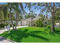 Inviting home with a verdant lawn and mature trees offering shade and curb appeal at 3404 W Villa Rosa St, Tampa, FL 33611