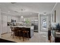 Bright kitchen with island, stainless steel appliances, and eat in seating adjacent to the front door at 3404 W Villa Rosa St, Tampa, FL 33611