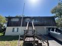 Two-story home featuring an exterior staircase with garage parking and exterior balcony at 359 S Orchid Dr, Ellenton, FL 34222
