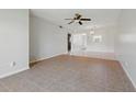 A bright living room with tile flooring and a ceiling fan at 1415 Doolittle Ln # 106, Dunedin, FL 34698