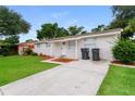 Well-maintained exterior featuring a lush front lawn, textured facade, and a welcoming entrance at 6426 Eden Ln, Tampa, FL 33634
