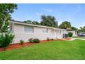 Attractive exterior with a neat lawn, complementary landscaping, and a driveway for convenient parking at 6426 Eden Ln, Tampa, FL 33634