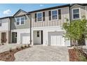 Attractive townhouses with neutral siding, one-car garage, and professionally landscaped front yards at 7288 Deer Valley Circle, Tampa, FL 33635