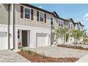 Inviting townhouse exteriors with a neutral color palette, a one-car garage, and landscaped front yards at 7288 Deer Valley Circle, Tampa, FL 33635
