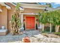 Close up of the front door surrounded by lovely shrubbery and lush foliage at 14680 Linden Dr, Spring Hill, FL 34609