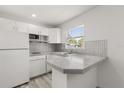 Bright white kitchen with modern appliances and a stylish backsplash at 1465 Pierce St, Clearwater, FL 33755