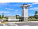 Community entrance sign for Persimmon Park at Wahoo Ranch under a bright blue sky at 28875 Seedling St, Wesley Chapel, FL 33543