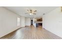 Open-concept living room features wood floors and flows into the kitchen area for easy entertaining at 5329 Companion Ln, Tampa, FL 33619