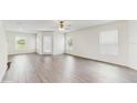 Sunlit living room with wood floors, white walls, and multiple windows creating a bright and airy atmosphere at 5329 Companion Ln, Tampa, FL 33619