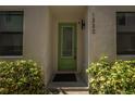Close-up of the unit's front door surrounded by lush, manicured bushes at 1332 W Gray St # 6, Tampa, FL 33606