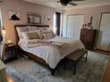 Serene main bedroom featuring a king bed with a plush rug, warm lighting, and ample closet space at 4419 Waltham Dr, Tampa, FL 33634