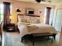 Comfortable main bedroom with a large bed, soft rug, neutral colors, and a ceiling fan at 4419 Waltham Dr, Tampa, FL 33634