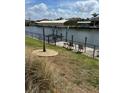 Dock area with boat lift, waterfront access, and a bench perfect for relaxing at 8252 Tecumseh Cir, Port Charlotte, FL 33981