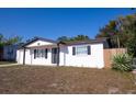 Side view of a well-maintained single-story home with a manicured lawn at 9235 Richwood Ln, Port Richey, FL 34668