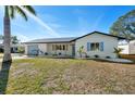 Inviting home with blue shutters, a well-manicured lawn, and fresh, modern landscaping at 105 12Th Sw St, Ruskin, FL 33570