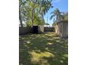 Spacious backyard with a wooden fence and a trailer, ideal for storage and recreational use at 1317 W Alicia Ave, Tampa, FL 33604