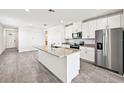 Modern kitchen with stainless steel appliances, granite countertops, and a large kitchen island at 14005 Crutchfield Ct, Parrish, FL 34219